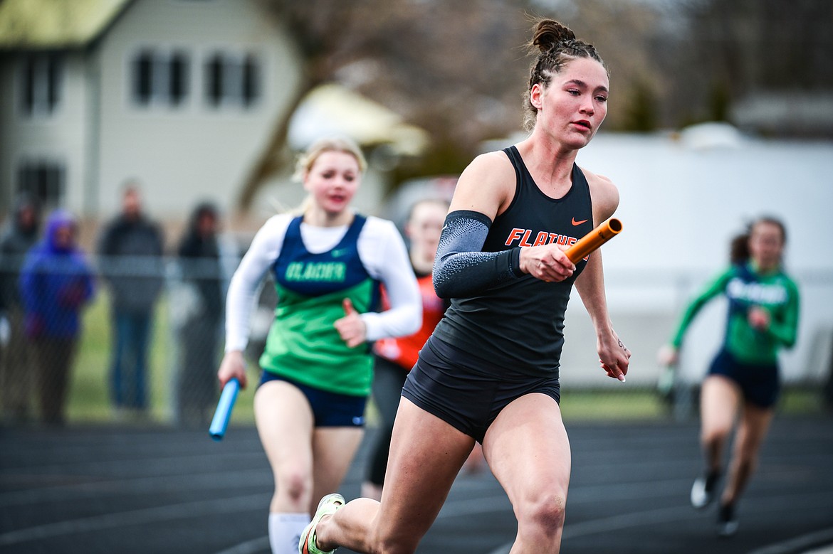 Flathead's Peyton Walker runs the first leg of the 4 x 100 relay during a crosstown track meet with Glacier at Legends Stadium on Tuesday, April 18. (Casey Kreider/Daily Inter Lake)