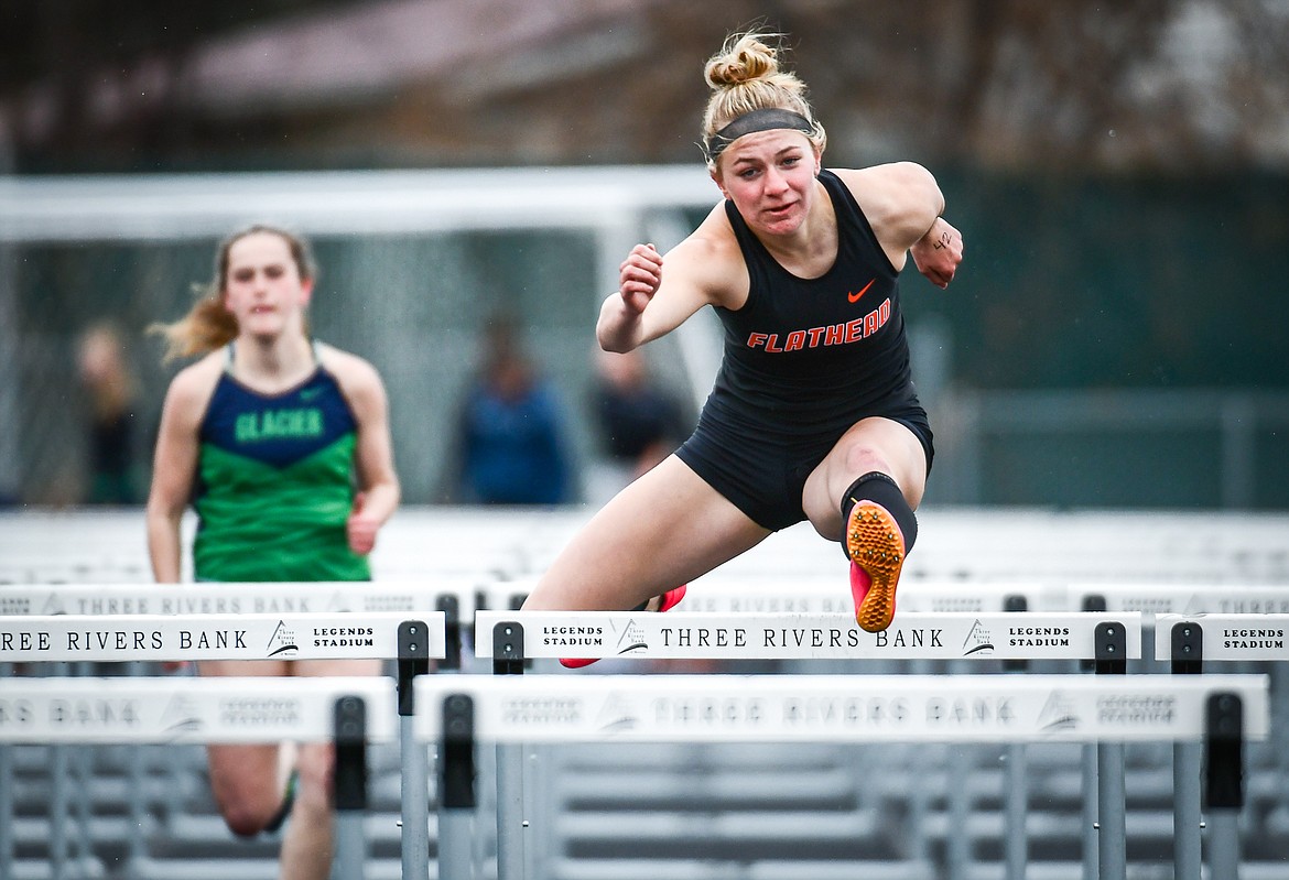 Flathead's Alivia Rinehart clears a hurdle en route to a first place finish in the 100 meter hurdles during a crosstown track meet with Glacier at Legends Stadium on Tuesday, April 18. (Casey Kreider/Daily Inter Lake)