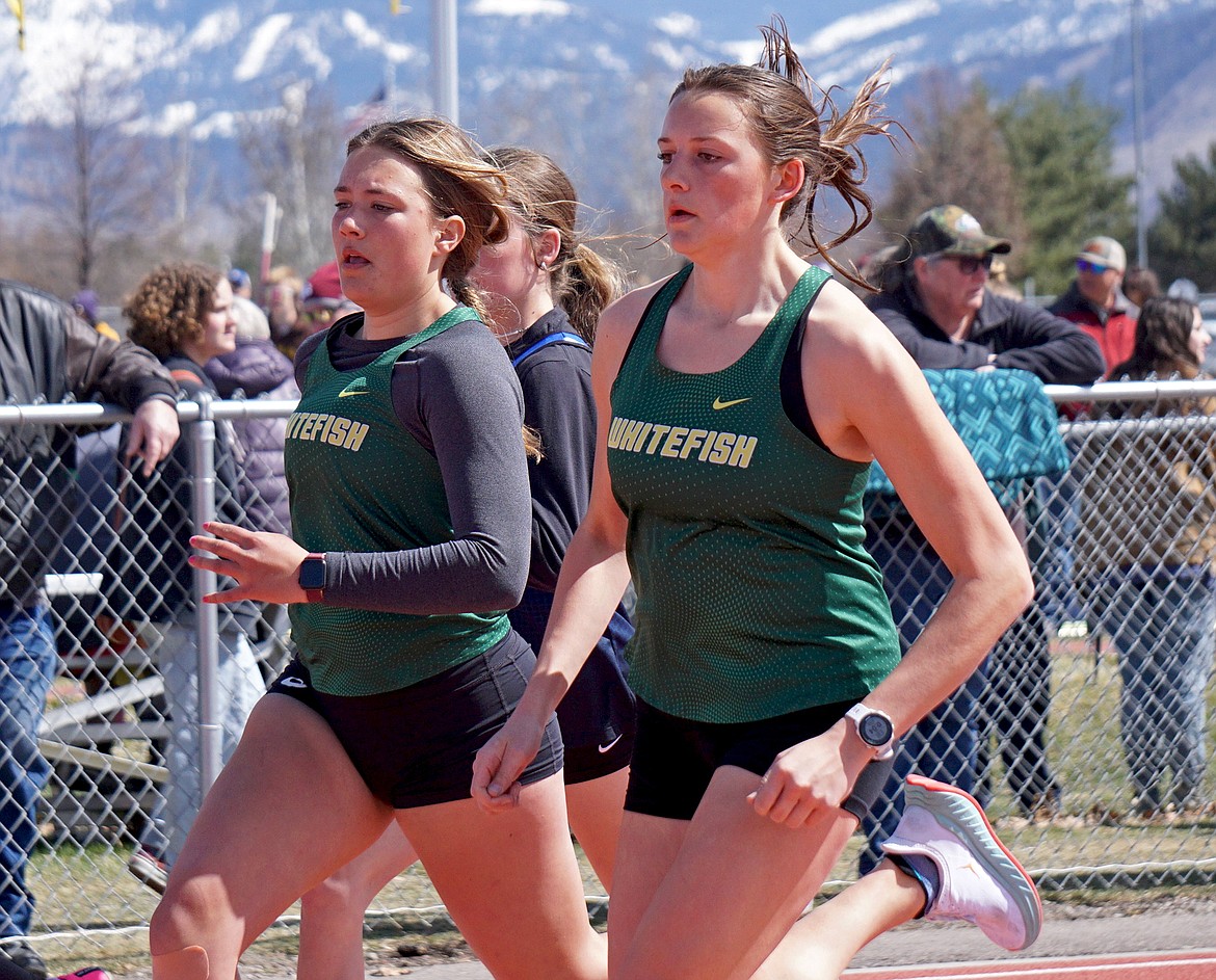 Whitefish's Maggie Pulsifer and Madelyn Alexander vie for position in the women’s varsity 800 meter race on Saturday. (Matt Weller photo)