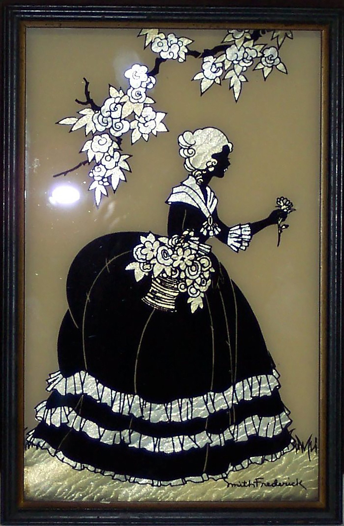 Titled “Old Fashioned Garden," it was created around 1933 by artist Helen L. Smith. The silhouette is painted on glass in reverse with foil under the glass to present a “pearly quality which makes it spring to life.”