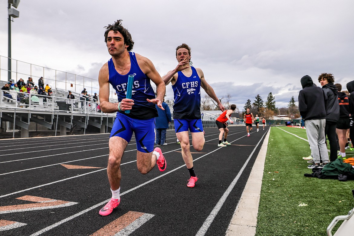 Jace Duval gets the baton from Adam Schrader in the 4x400m relay at the Flathead Time Trials in Kalispell last week. (JP Edge photo)