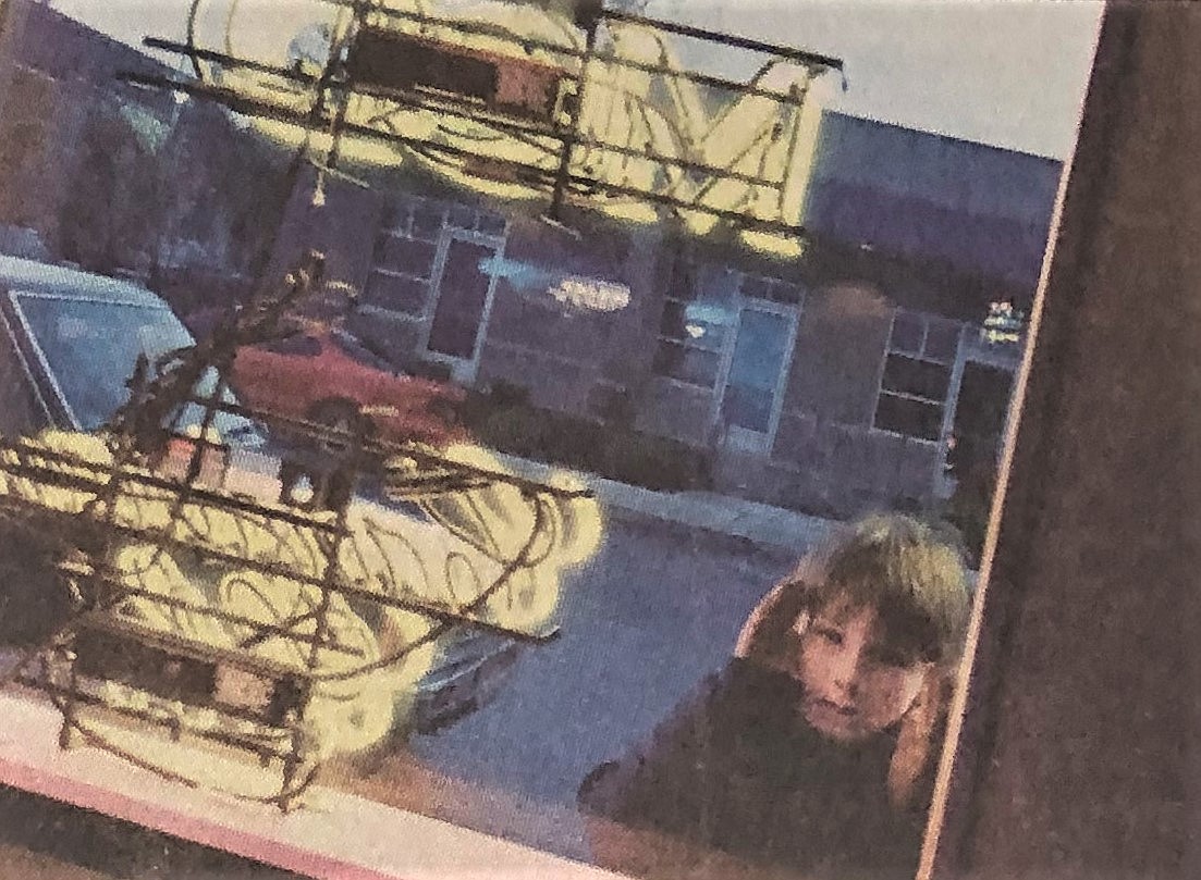 A boy peeps into the Torch Lounge after removal of curtains.