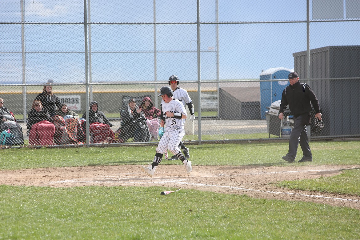 ACH sophomore Carter Pitts (15) escapes a rundown to score a run in the bottom of the first inning against Columbia (Hunters) on Tuesday.