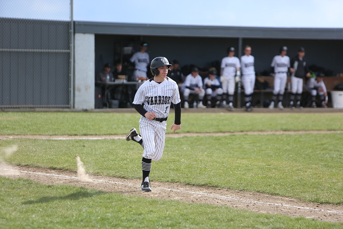 ACH junior Everett Wood spring to first base after making contact with a pitch.