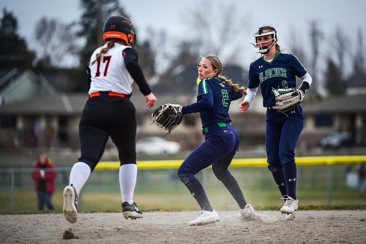 Glacier second baseman Kenadie Goudette (2) fires to first but can't complete the double play after backhanding a grounder in the fourth inning against Flathead at Kidsports Complex on Thursday, April 20. (Casey Kreider/Daily Inter Lake)