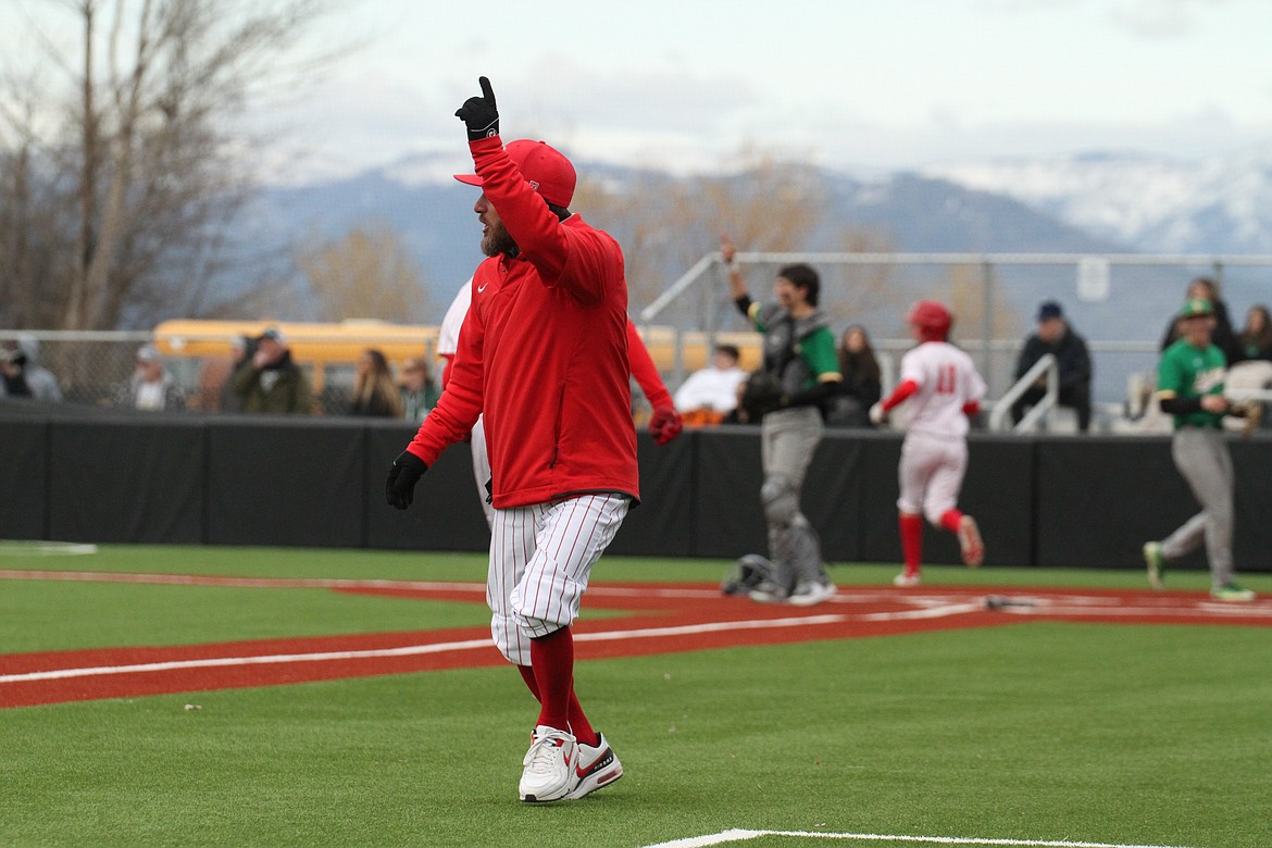 Head coach Ricky Klontz celebrates after an RBI double by Finn Mellander.