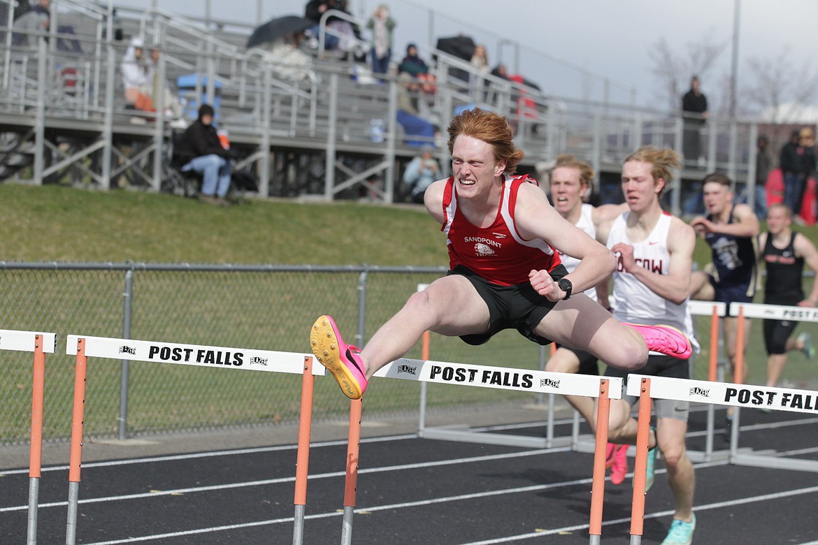 Rusty Lee clears a hurdle in Tuesday's meet at Post Falls High School. Lee won the 110-meter hurdles with a time of 15.01 seconds.