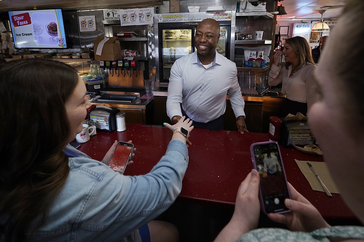 Sen. Tim Scott, R-S.C., shakes hands with diners at the breakfast counter during a visit to the Red Arrow Diner, Thursday, April 13, 2023, in Manchester, N.H. (AP Photo/Charles Krupa, File)
