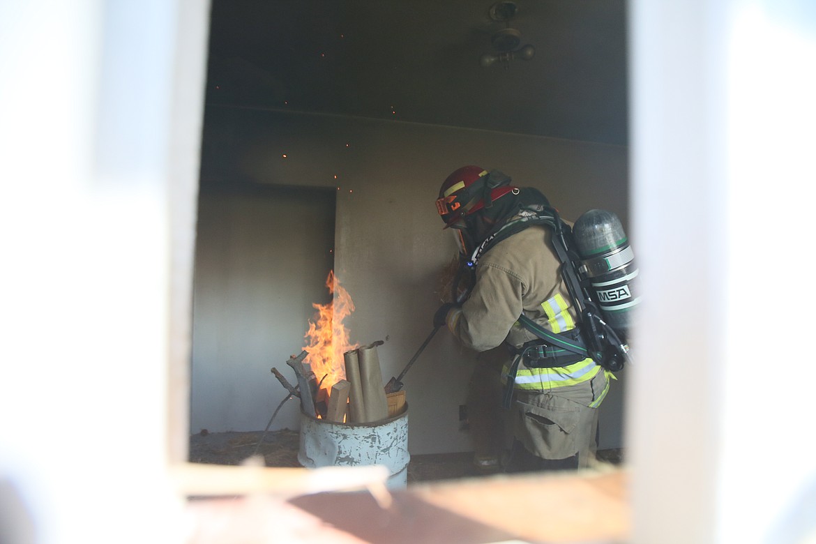 Hauser Fire Capt. Gary Mobbs torches flammable material in a burn barrel Saturday morning during a training exercise.