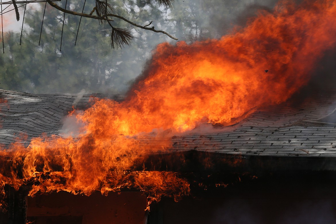 Fire devours a roof Saturday during a burning exercise at Pleasant View Road and Highway 53.