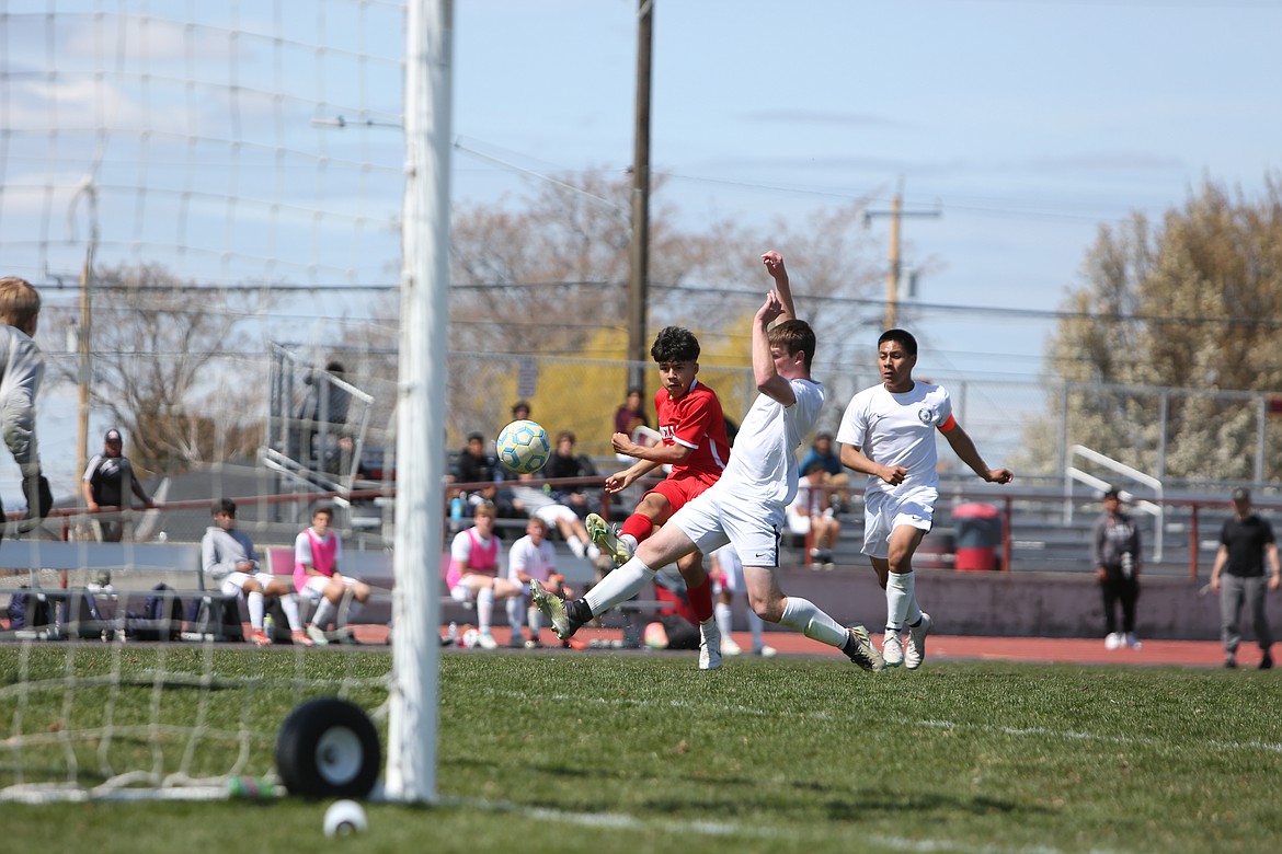 Othello sophomore Ruben Mancilla, in red, scores off a shot during the second half of Saturday’s 5-1 win over Selah.