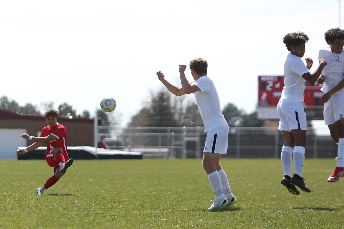 Othello junior Cristian Torres, in red, takes a penalty kick during the first half against Selah.