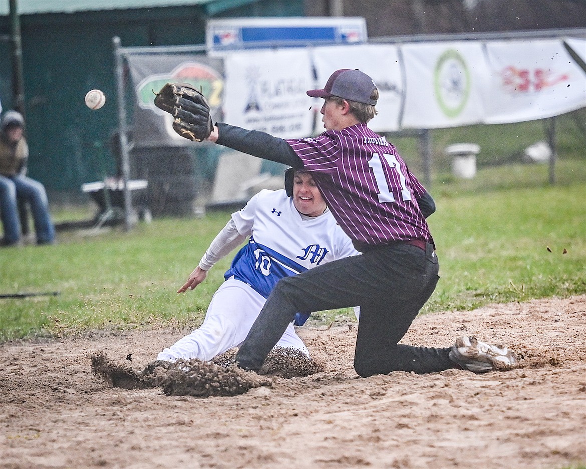 Mission Bulldog Sheldon McLeod steals home while Troy pitcher Cody Todd tries to make the tag during last Friday's home game. (Christa Umphrey photo)