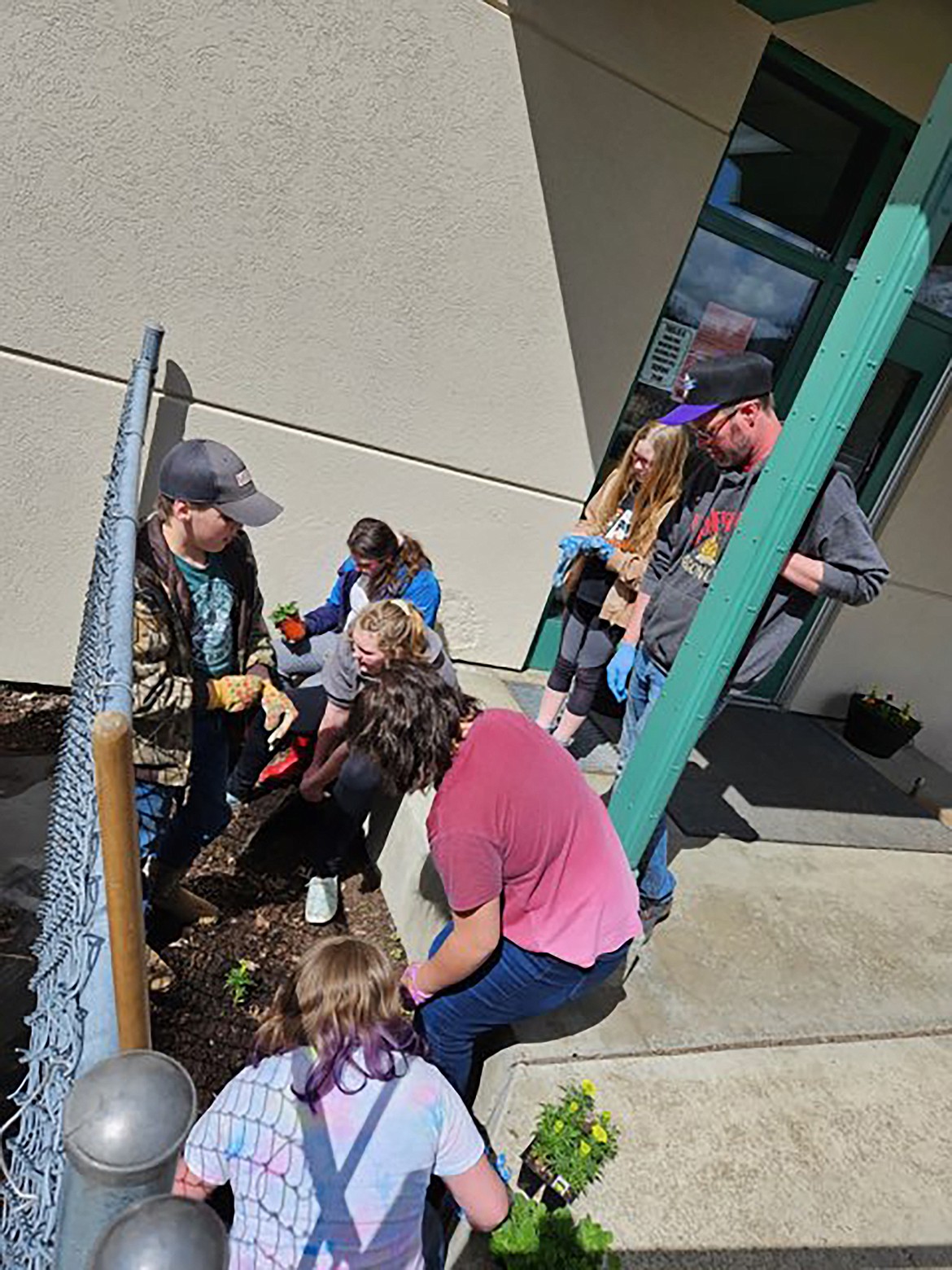 Idaho Hill fifth- and sixth-grade students help spruce up the entry to the school at last week's Earth Day event.