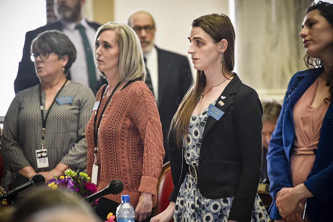 Rep. Zooey Zephyr, D-Missoula, second from right, stands with members of the minority party on the house floor on Thursday, April 20, 2023 at the state capitol in Helena, Mont. (Thom Bridge/Independent Record via AP)