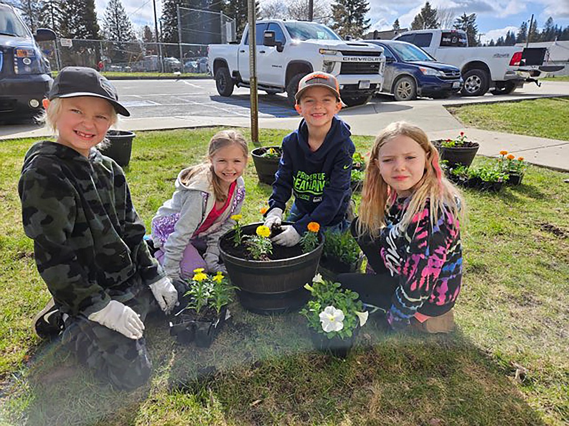 A group of Idaho Hill kindergarten and first-grade students take a break for a photo while helping out at last week's Earth Day events.