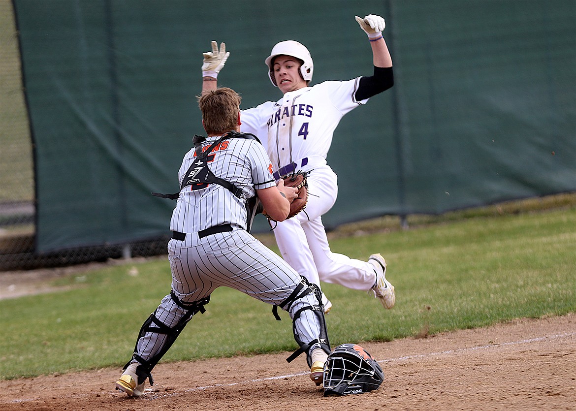 Pirate Landon Shoemake is caught stealing home during game against Eureka.