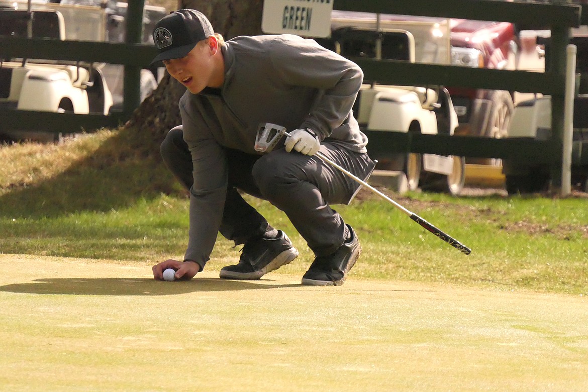 St. Regis junior John Pruitt lines up a putt during Saturday's Gary Thompson Invitational tournament at River's Bend Golf Course near Thompson Falls. (Chuck Bandel/VP-MI)