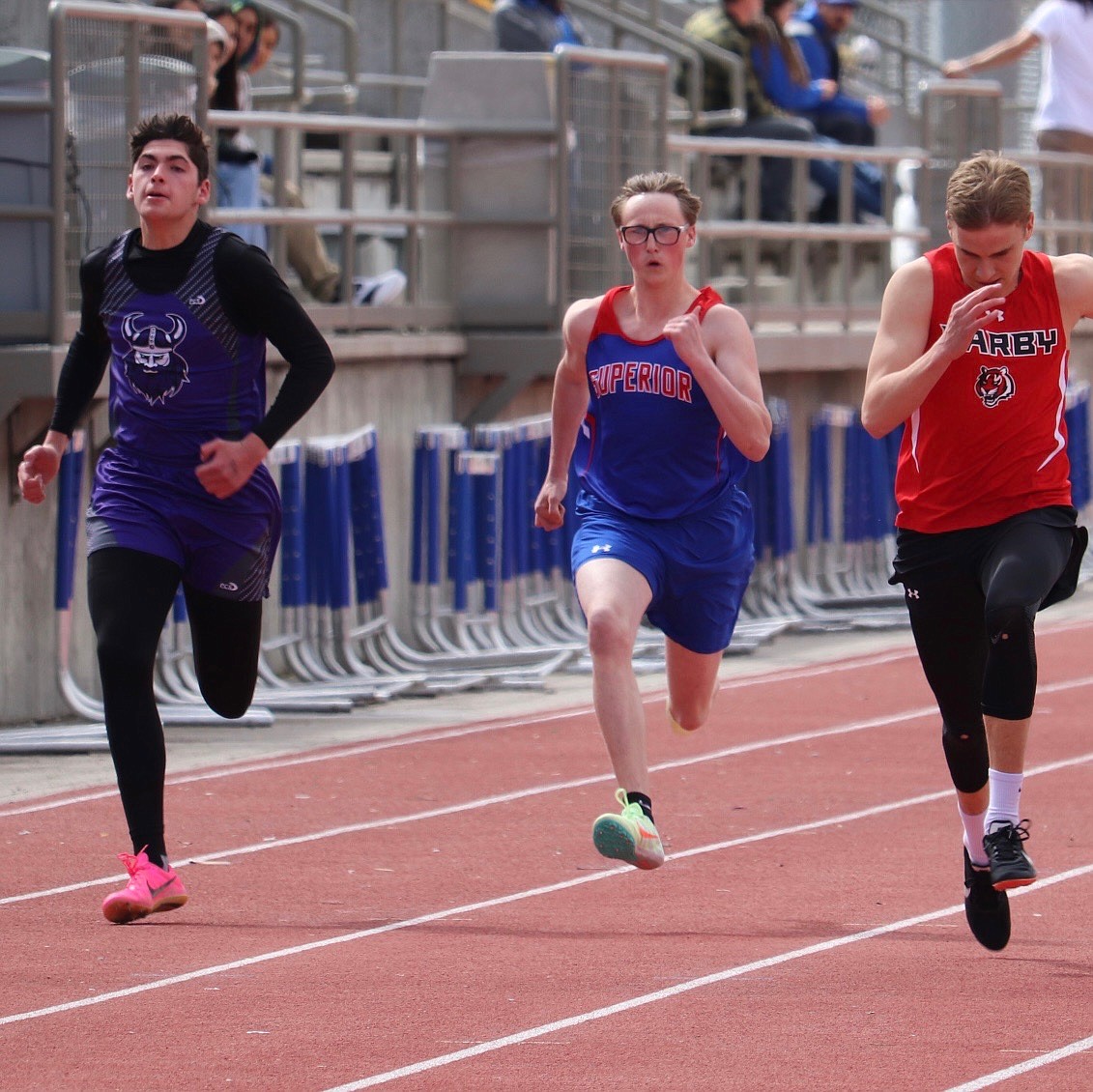 Superior sprinter Ramsey Boyle (middle) strains during the men's 100 meter sprint event at this past Saturday's Seeley-Swan Invitational in Missoula.  (Kami Milender photo)