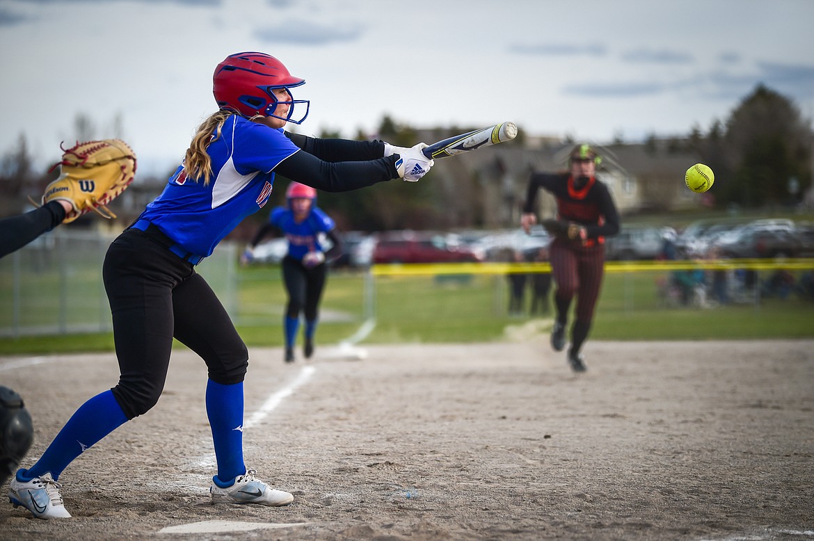 Columbia Falls' Sydney Mann (14) scores Aspen Dawson from third with a bunt single in the third inning against Flathead at Kidsports on Tuesday, April 25. (Casey Kreider/Daily Inter Lake)