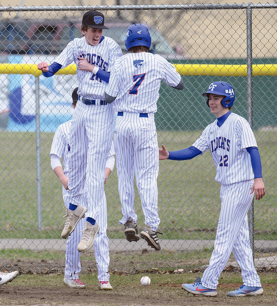 Dayne Tu and Reggie Sapa, right celebrate with Kellen Kroger (7) after he hit an inside the park homer against Browning.