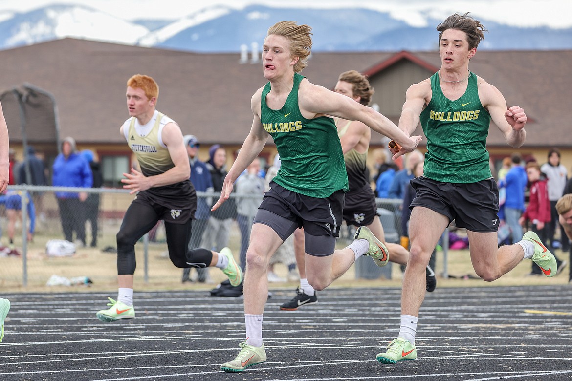 Azure Stolte and Riley Zetooney compete in the varsity boys 4x100 relay at the Iceberg Invite in Columbia Falls on Saturday. (JP Edge photo)