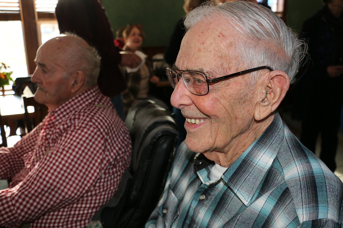 Darrell Ewing, pictured left, smiles as he listens to a story at his birthday celebration on Tuesday.