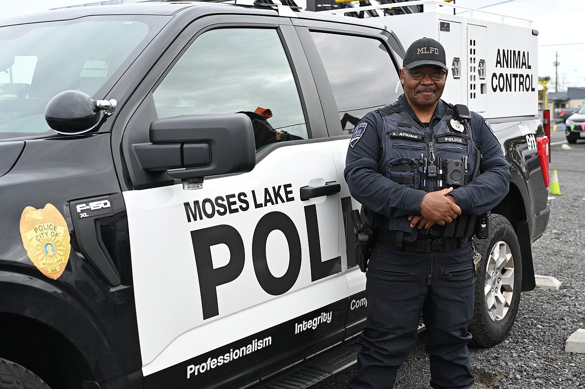 Moses Lake Police Code Enforcement Officer Lucky Atkins in front of his animal control truck at the Mothers of Preschoolers Touch a Truck fundraiser on Saturday in Moses Lake.