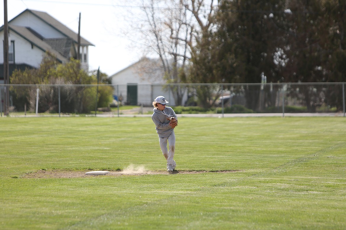 Warden freshman Eli Cox throws a ball from second base during a Cougar practice.