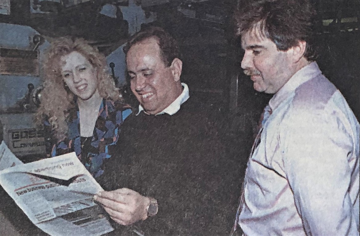 Frank Granier (center) reviews the first issue of the North Idaho Business Journal, with Cheri Andriolo and Ric Clarke