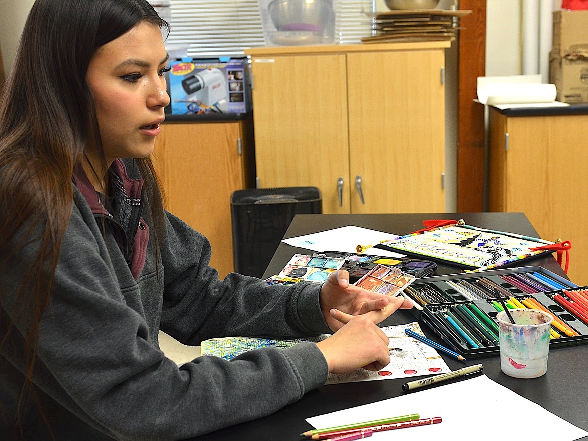 St. Ignatius High senior Cedar Hunt explains her process for creating ledger art. She's also an accomplished beadworker. (Kristi Niemeyer/Leader)