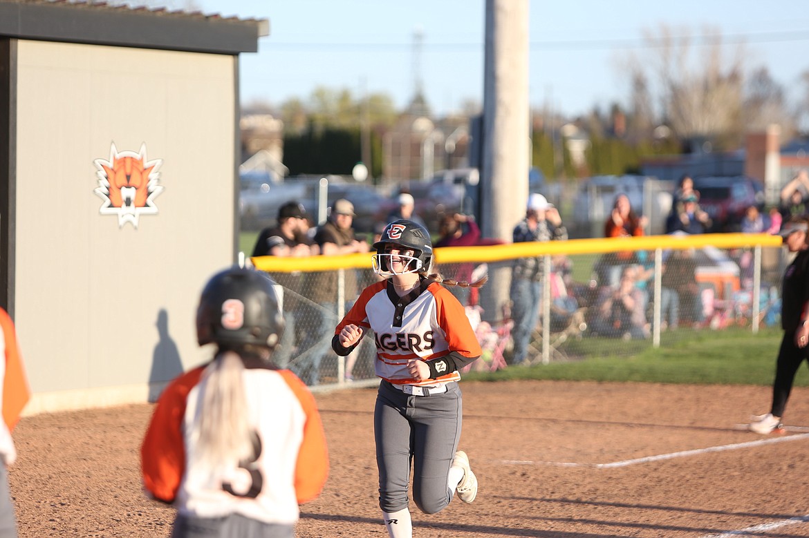 Ephrata junior Peyton Trautman smiles as she approached home plate after hitting a home run against Quincy.