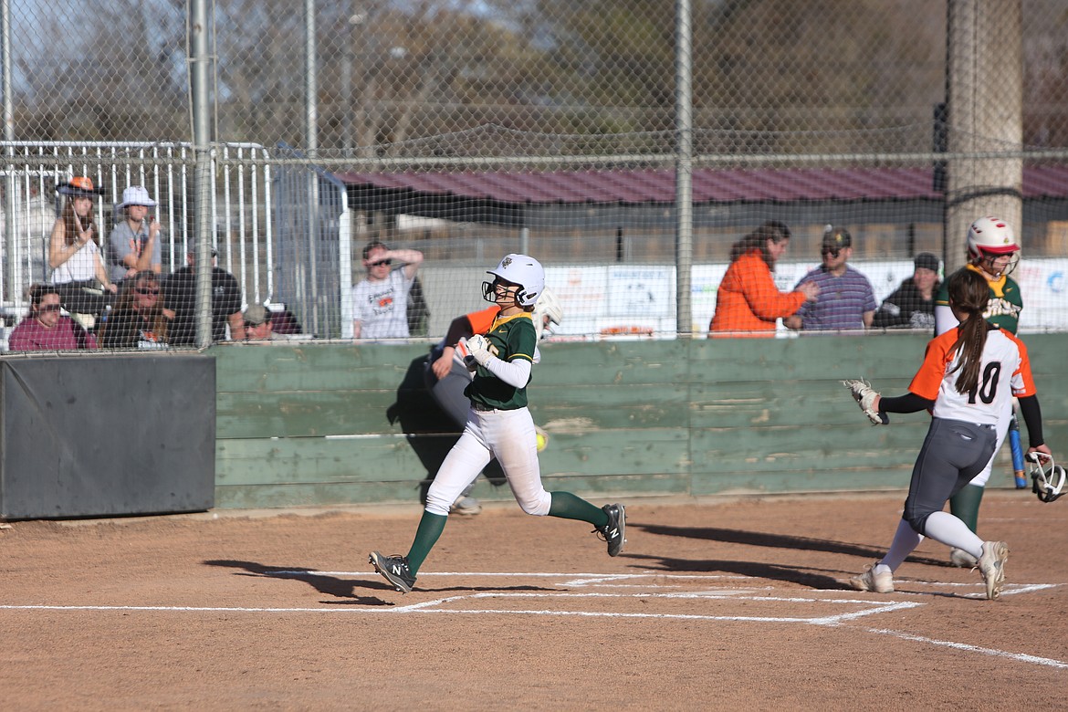 Quincy junior Emilee Morris crosses home plate during the first inning of Tuesday’s nightcap against Ephrata.