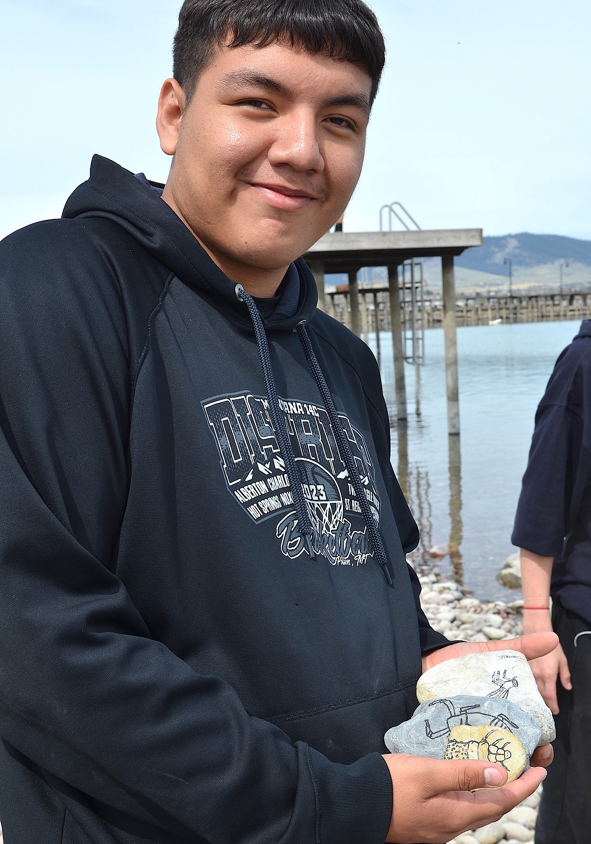 Ryiley Gates of Two Eagle River School displays a stack of rocks he collected along Flathead Lake, marked with invasive species, during a recent Mussel Rock. (Kristi Niemeyer/Leader)