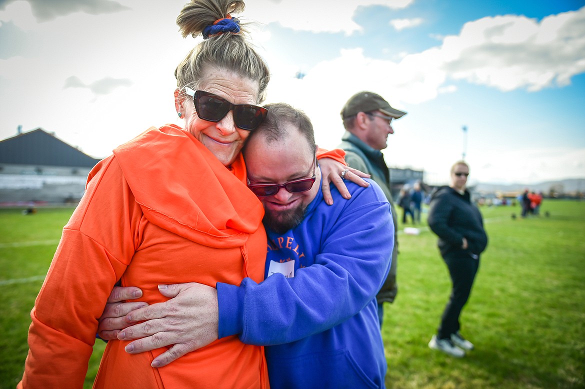 Lynette Erickson gets a hug from the Kalispell Krushers' Jeremy Minnehan at the Special Olympics Glacier Area Spring Games outside Legends Stadium in Kalispell on Thursday, April 27. The games continue Friday with track and field and cycling at Legends Stadium and aquatics at Logan Health Medical Center. (Casey Kreider/Daily Inter Lake)