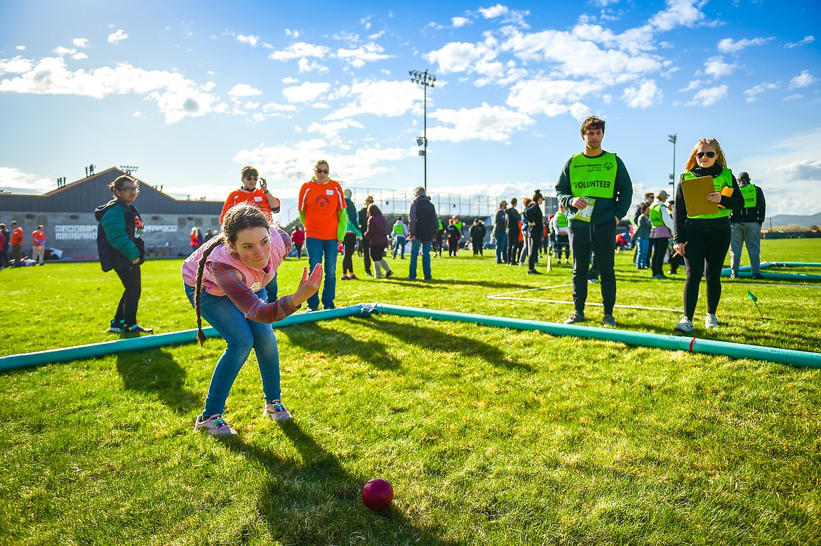 Hanna Adams with the Flathead High School team tosses the bocce ball at the Special Olympics Glacier Area Spring Games outside Legends Stadium in Kalispell on Thursday, April 27. The games continue Friday with track and field and cycling at Legends Stadium and aquatics at Logan Health Medical Center. (Casey Kreider/Daily Inter Lake)