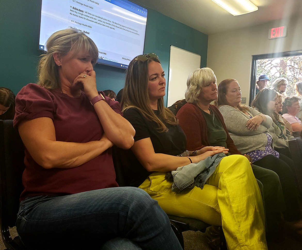 From left, Jodie DeVore and Amanda Leach watch in suspense as the Lakeland Joint School District Board of Trustees discuss approving or denying an agreement that allows Heritage Health to meet with patients who are students of the district on campuses.