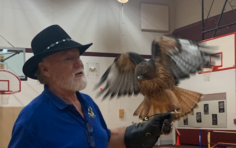 Don Veltkamp of the Birds of Prey Northwest nonprofit shares information about hawks and other raptors during a visit April 13 to Fernan STEM Academy.