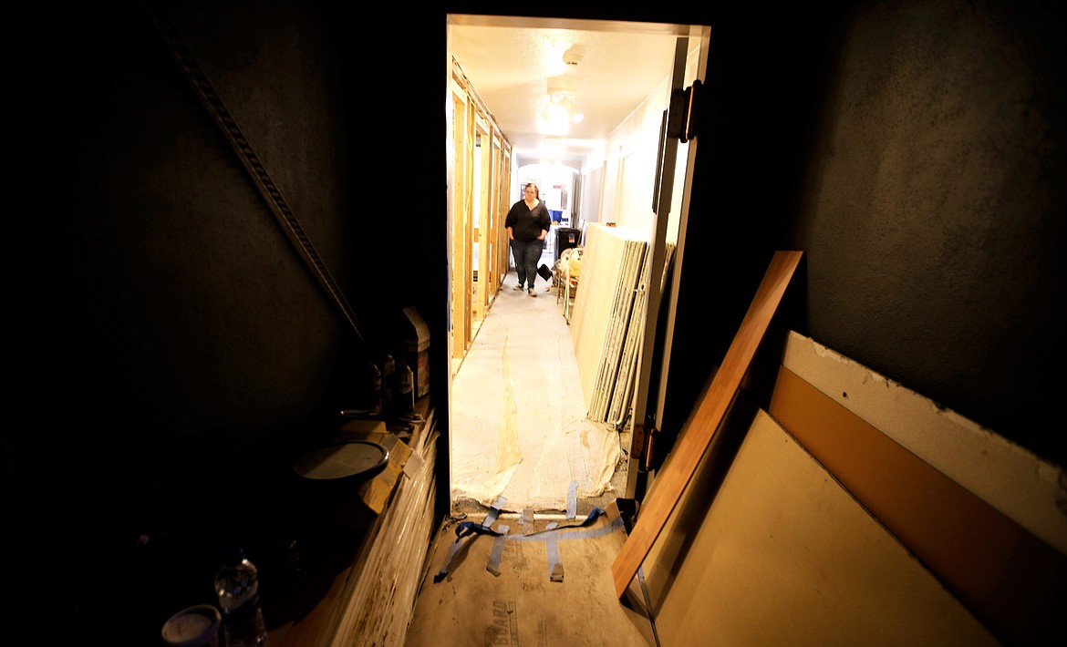 Jessica Peterson walks through a hallway under construction at the Lake City Playhouse.