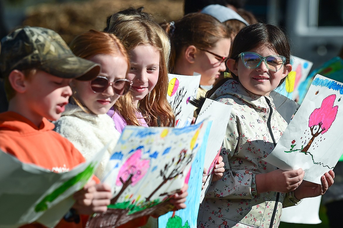 Third-grade students from Edgerton Elementary School teacher Jess Hensley's class read the poem "Trees" by Harry Behm at the Arbor Day celebration at Woodland Park in Kalispell on Friday, April 28. (Casey Kreider/Daily Inter Lake)