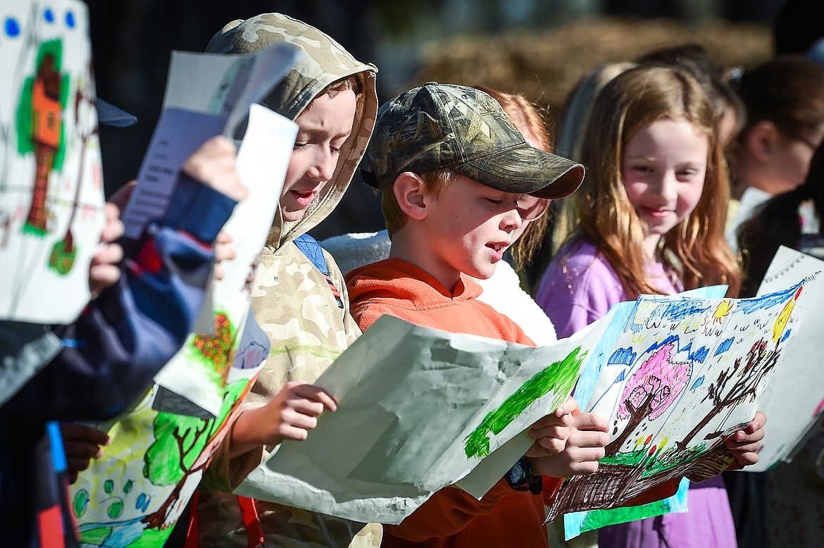 Third-grade students from Edgerton Elementary School teacher Jess Hensley's class read the poem "Trees" by Harry Behm at the Arbor Day celebration at Woodland Park in Kalispell on Friday, April 28. (Casey Kreider/Daily Inter Lake)
