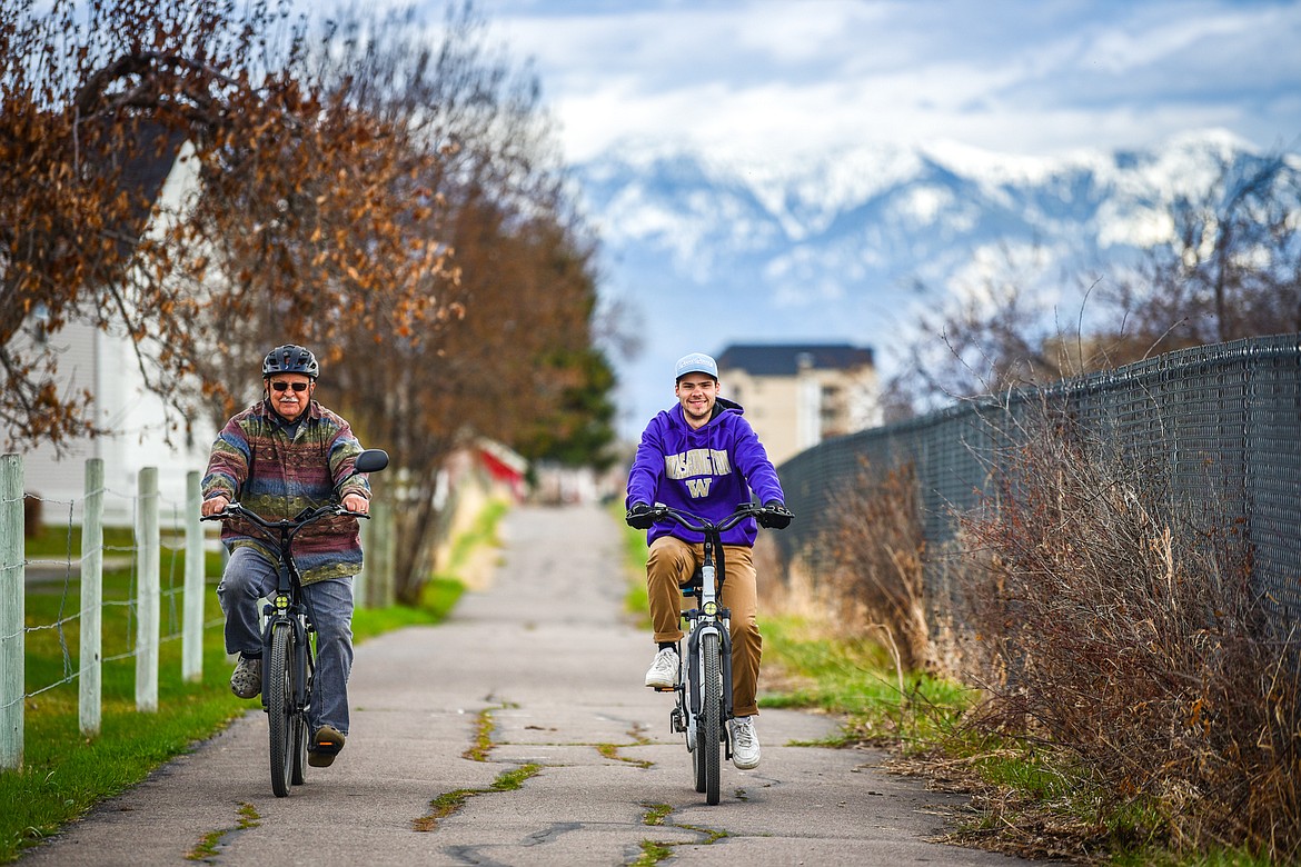 Tony Dupont and Quinten Joos ride bikes along a section of the Great Northern Historical Trail west of Meridian Road in Kalispell on Wednesday, April 26. Kalispell City Council recently gave the go-ahead to purchase a tract of vacant railway land along this stretch of trail to extend the city's Parkline Trail. (Casey Kreider/Daily Inter Lake)