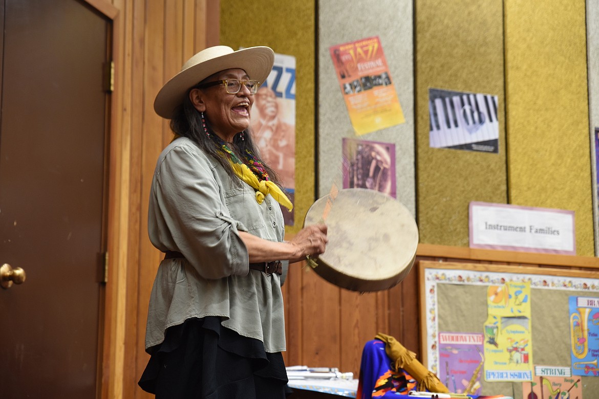 Piikani First Nation member Mary Ellen Little Mustache plays a drum for Libby Elementary School students at last Thursday's presentation. (Scott Shindledecker/The Western News)