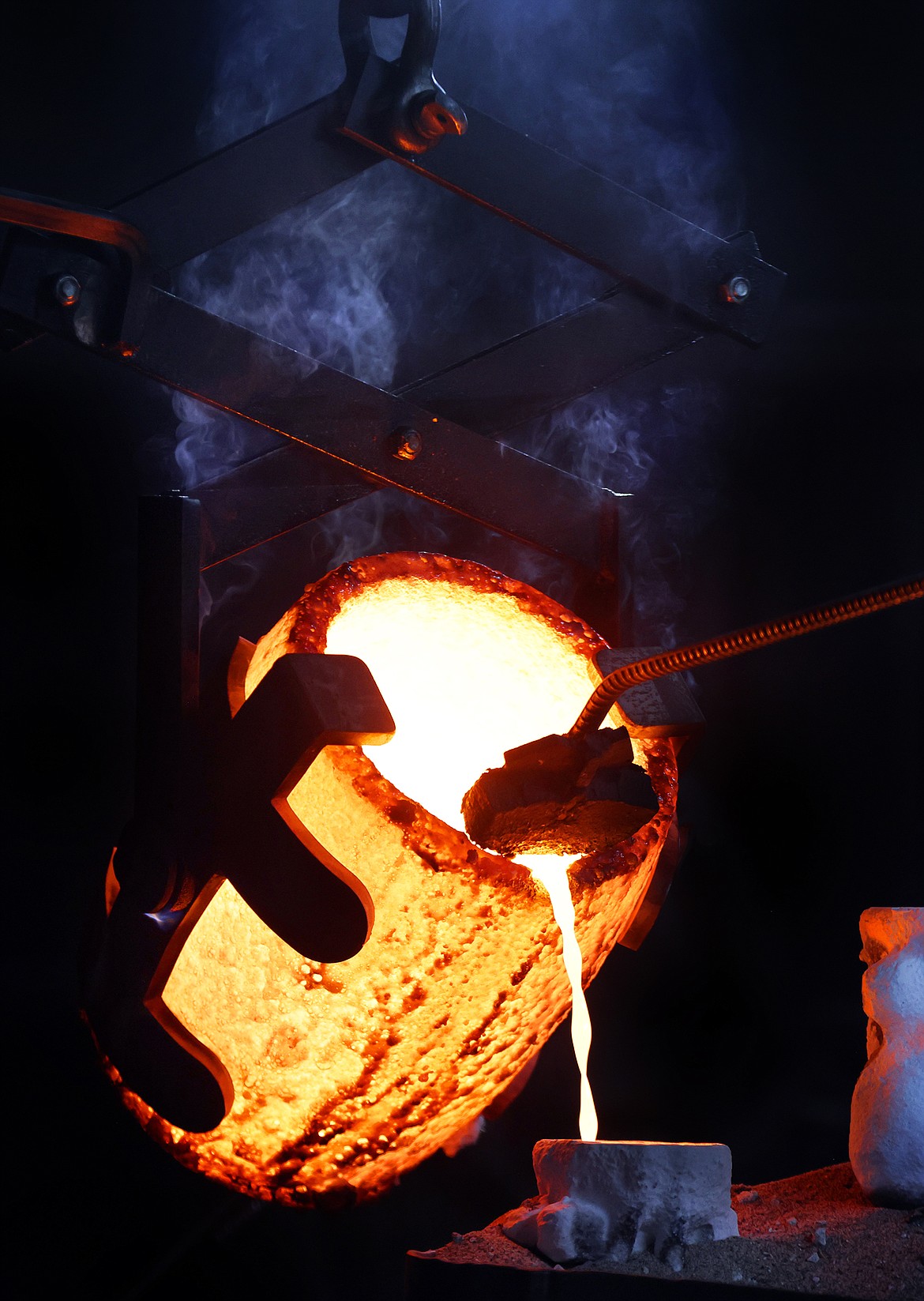 Molten bronze is poured into a mold during the process of creating a new cast sculpture at the Kalispell Art Foundry in Evergreen. (Jeremy Weber/Daily Inter Lake)