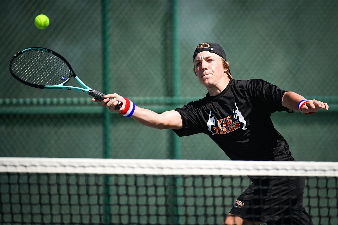 Flathead's Kobe Schlegel reaches for a return against Missoula Big Sky's Will Ruzanski at the Western AA Invite at FVCC on Saturday, April 29. (Casey Kreider/Daily Inter Lake)