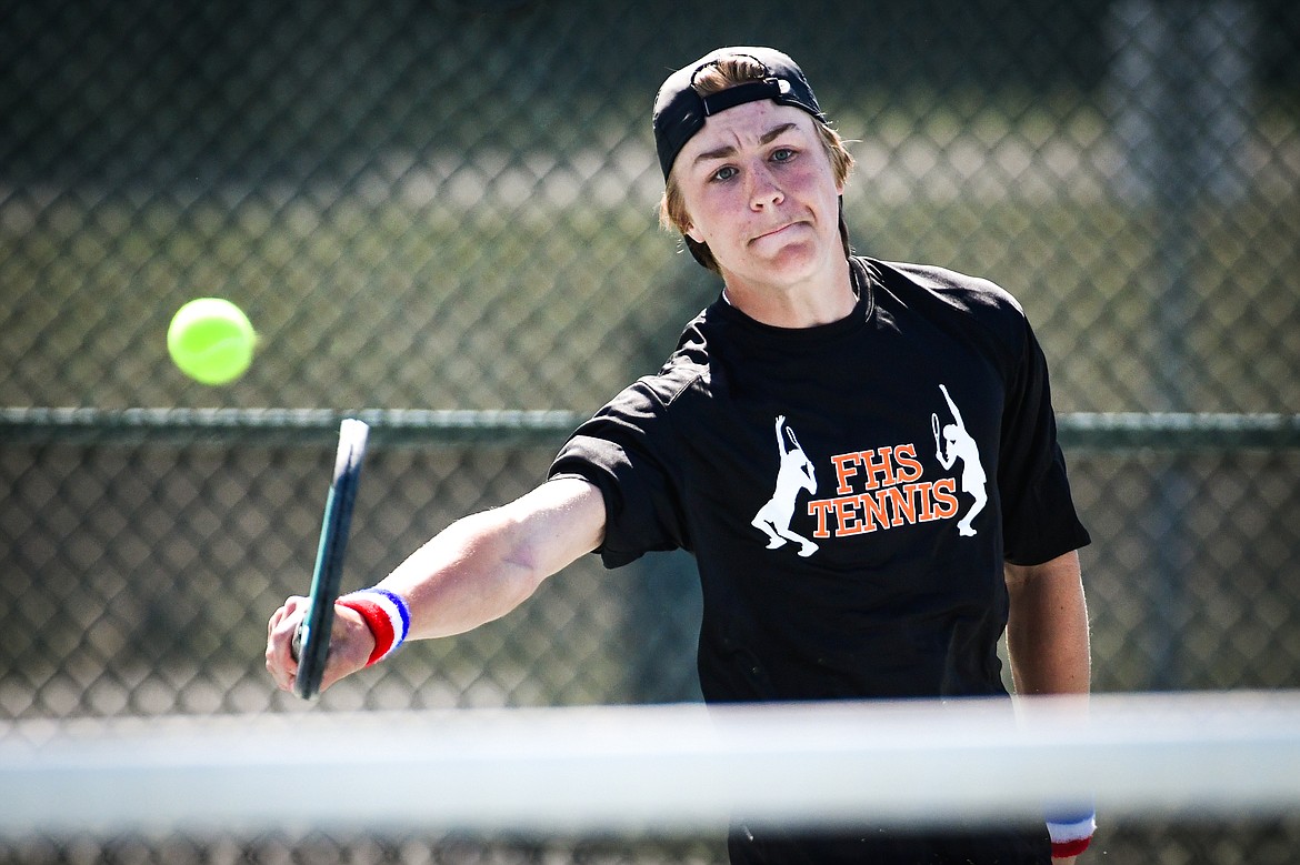 Flathead's Kobe Schlegel hits a backhand return against Missoula Big Sky's Will Ruzanski at the Western AA Invite at FVCC on Saturday, April 29. (Casey Kreider/Daily Inter Lake)