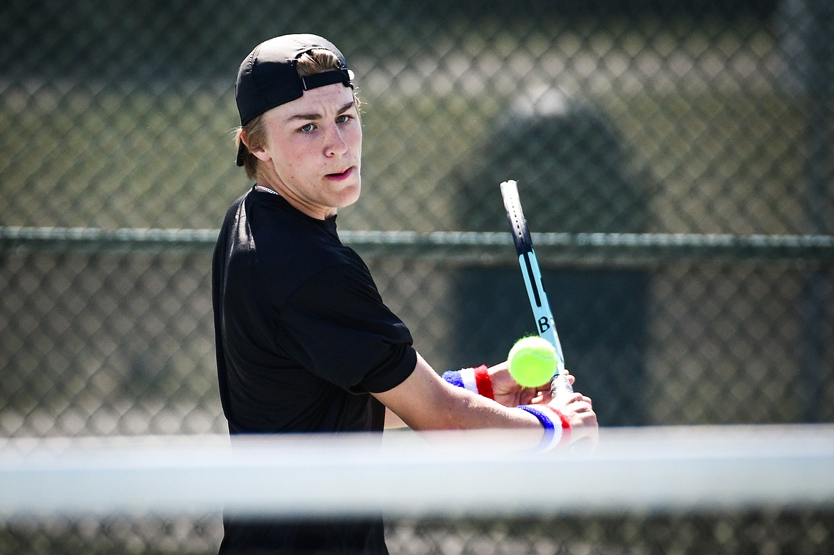 Flathead's Kobe Schlegel hits a backhand return against Missoula Big Sky's Will Ruzanski at the Western AA Invite at FVCC on Saturday, April 29. (Casey Kreider/Daily Inter Lake)