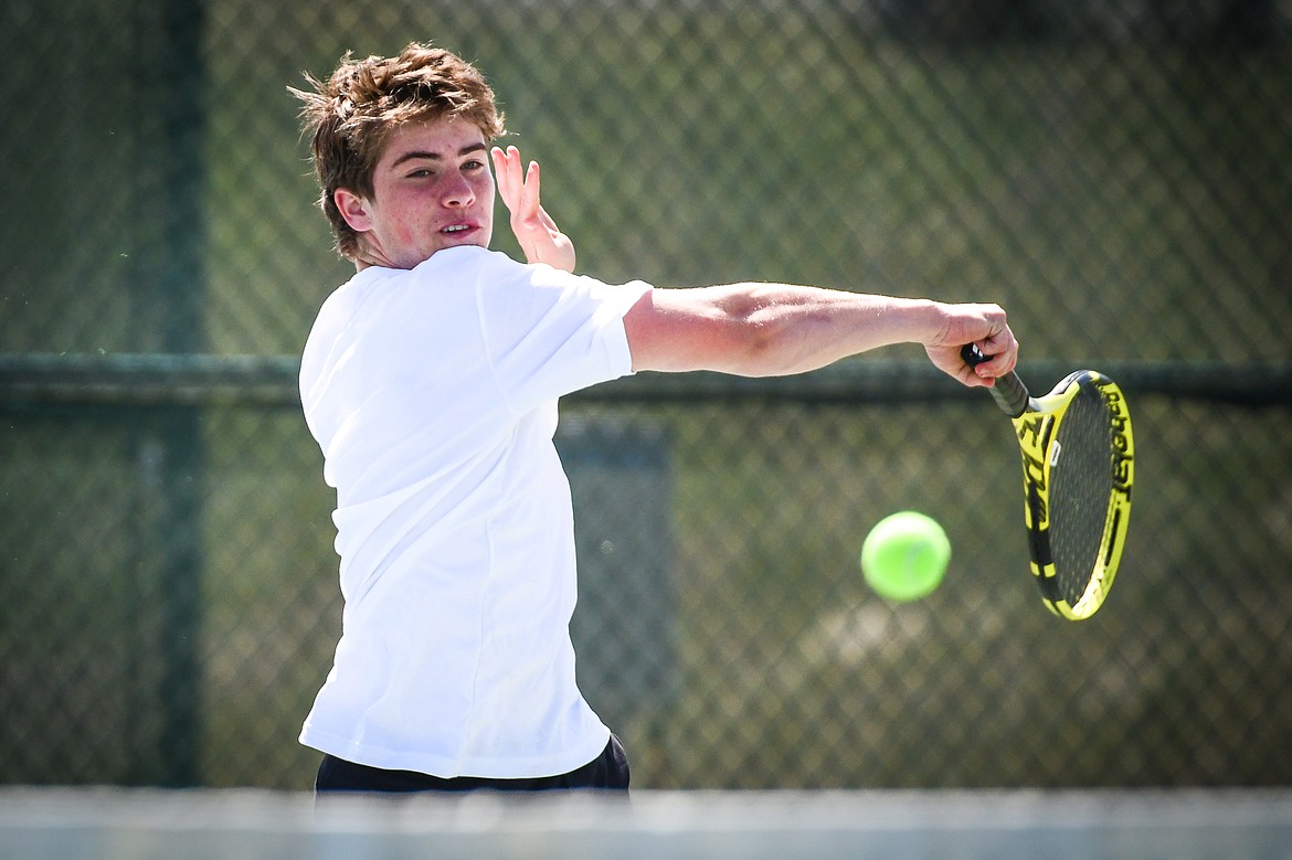 Glacier's Harrison Sanders smashes a forehand return in a doubles match with teammate Timmy Glanville against Glacier's Calvin Schmidt and Dalyn Mathison at the Western AA Invite at FVCC on Saturday, April 29. (Casey Kreider/Daily Inter Lake)