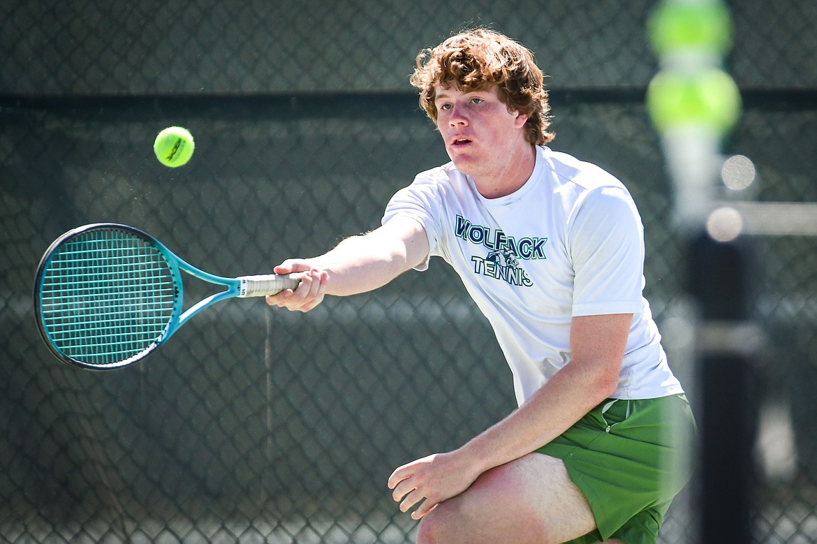 Glacier's Timmy Glanville reaches for a return in a boys doubles match with teammate Harrison Sanders against Glacier's Calvin Schmidt and Dalyn Mathison at the Western AA Invite at FVCC on Saturday, April 29. (Casey Kreider/Daily Inter Lake)