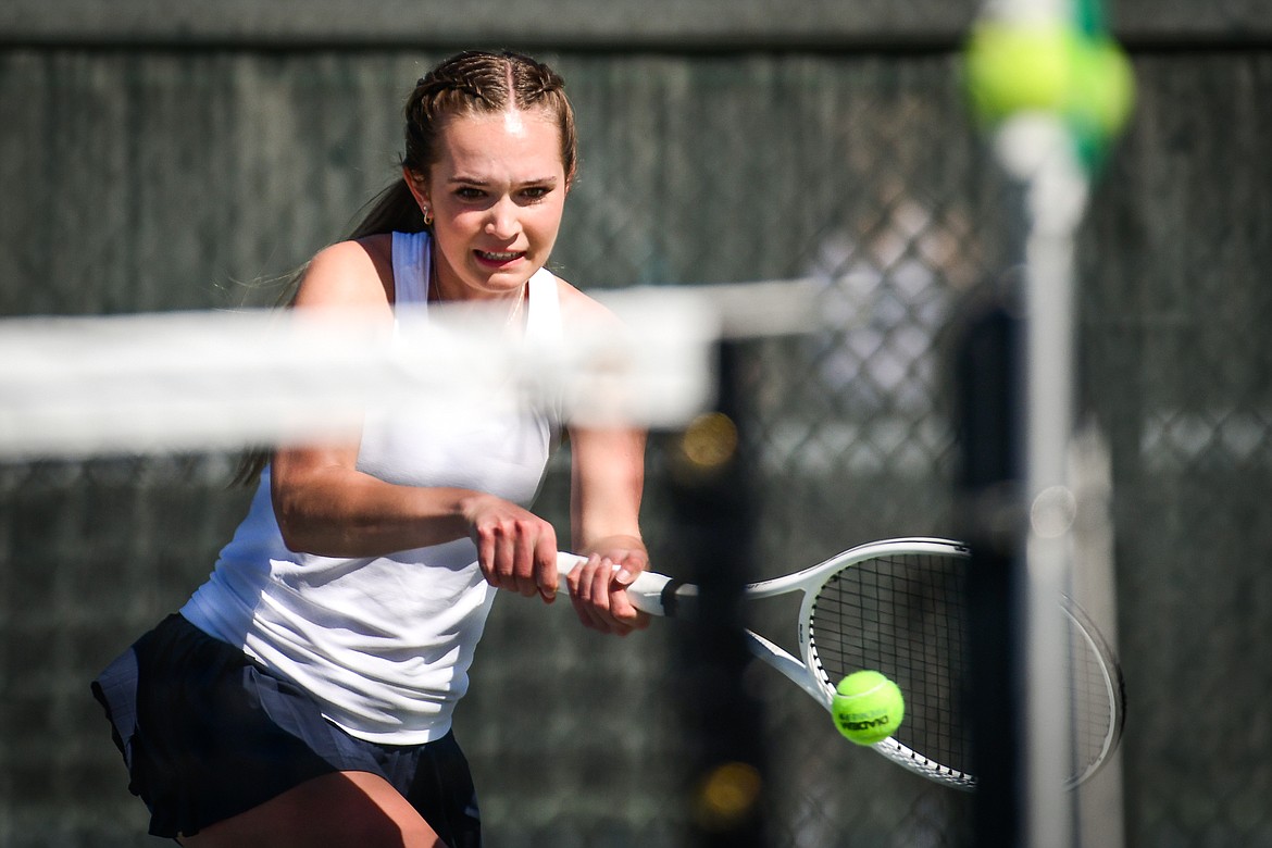 Glacier's Haven Speer hits a backhand return in a girls doubles match with teammate Sarah Downs against Missoula Big Sky's Kadyn Easter and Amber Williams at the Western AA Invite at FVCC on Saturday, April 29. (Casey Kreider/Daily Inter Lake)